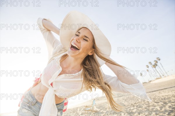 Caucasian woman playing on beach