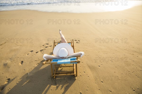 Caucasian woman laying on beach