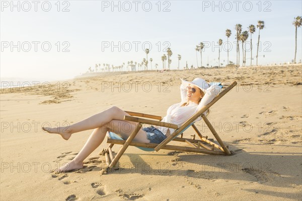 Caucasian woman laying on beach