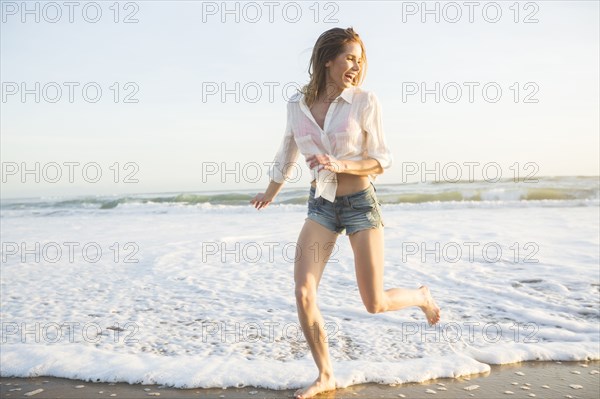 Caucasian woman playing on beach