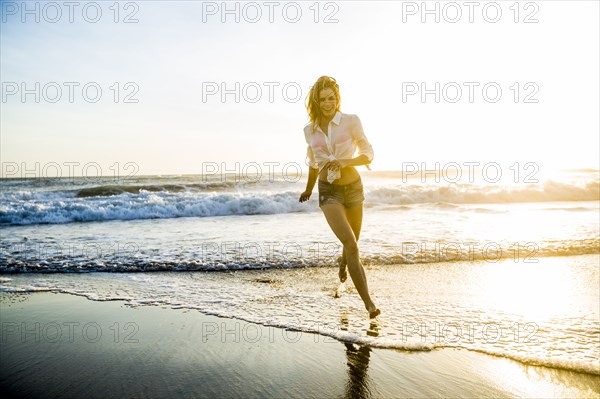 Caucasian woman playing on beach