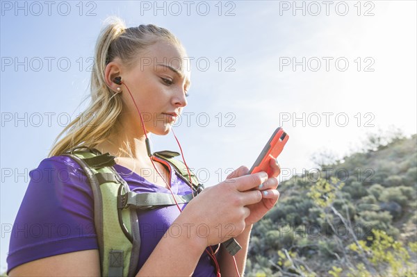 Caucasian woman using cell phone outdoors