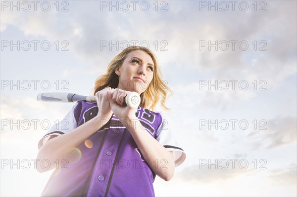 Caucasian teenage girl wearing softball uniform