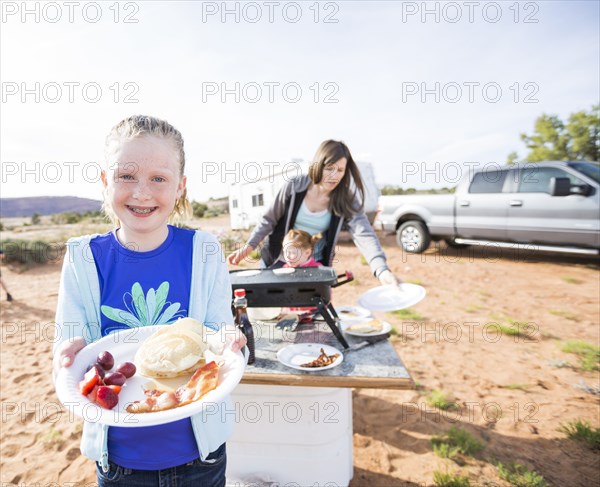 Caucasian girls showing plate of food