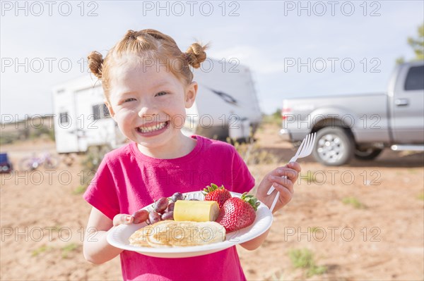 Caucasian girl posing with breakfast plate