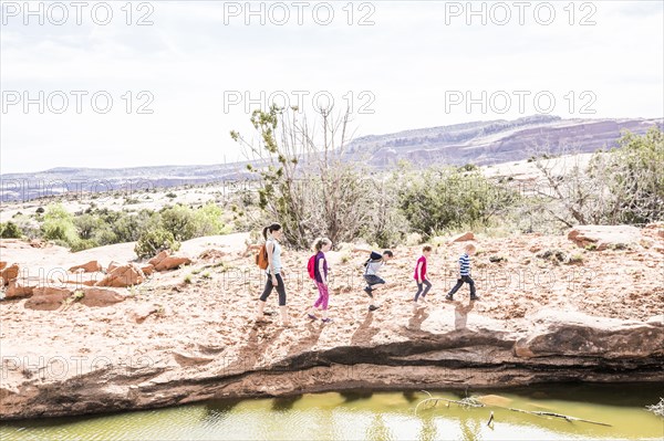 Caucasian mother and children hiking near river