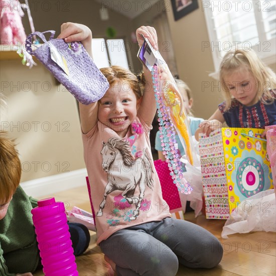 Caucasian girl showing gifts at party