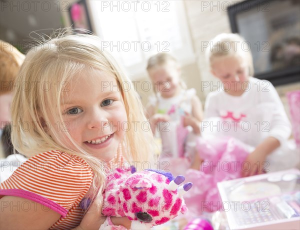 Caucasian girl holding gift at party