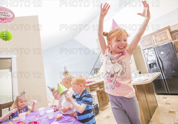 Caucasian girl wearing party hat cheering