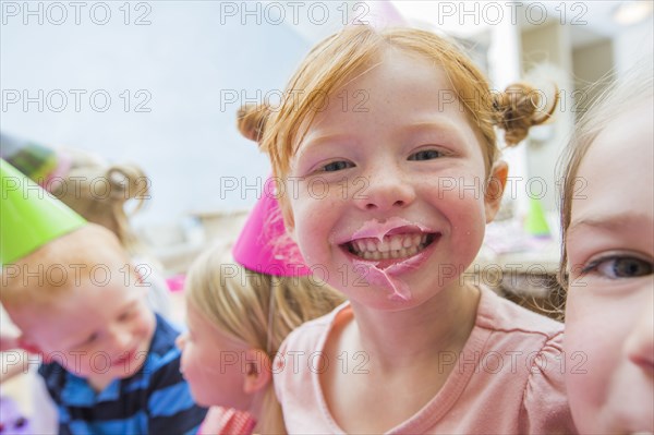 Caucasian girl with icing on lips at party