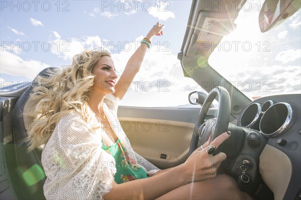 Caucasian woman driving in sports car