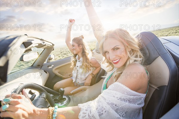 Caucasian women driving in sports car