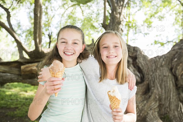 Caucasian girls eating ice cream cones