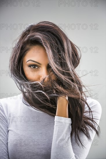 Hair blowing in face of Indian woman