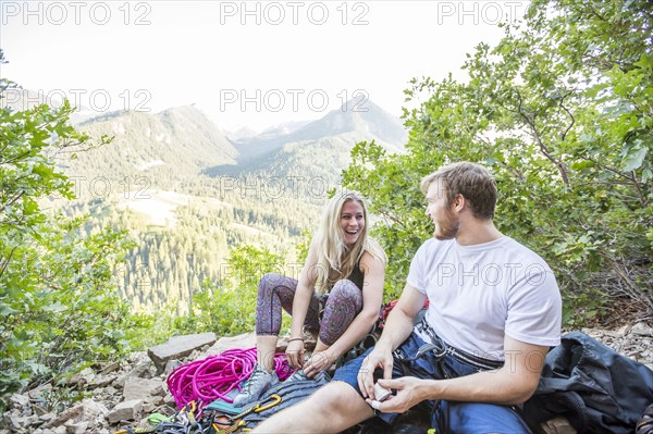 Caucasian couple preparing for rock climbing