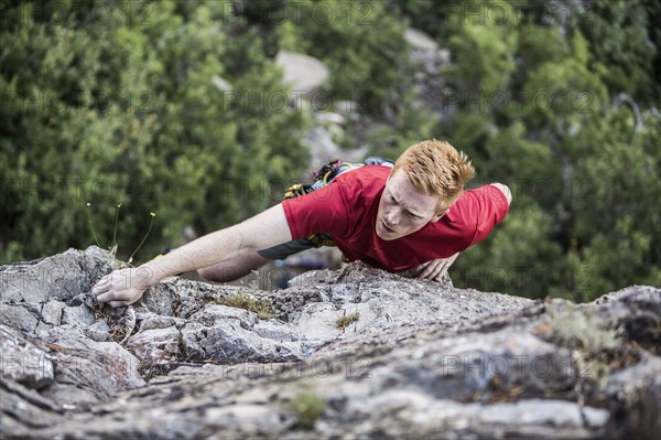 Caucasian man rock climbing