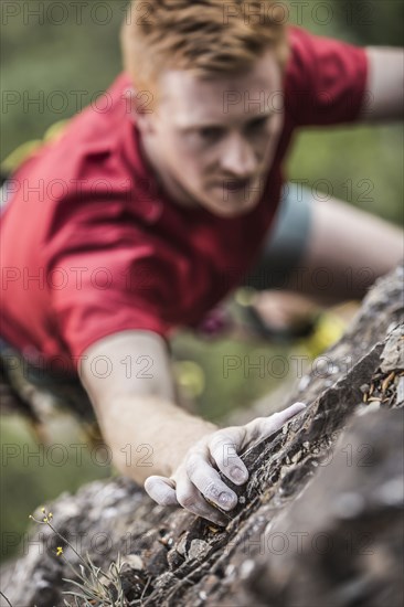 Caucasian man rock climbing