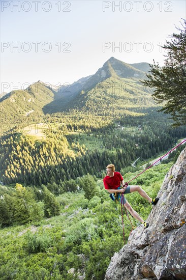 Caucasian man rock climbing