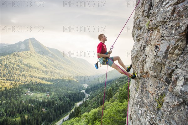 Caucasian man rock climbing