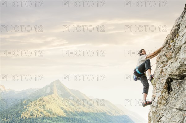 Caucasian man rock climbing