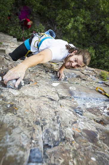 Caucasian man rock climbing