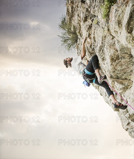 Caucasian man rock climbing