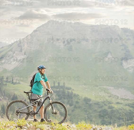 Caucasian man standing with mountain bike