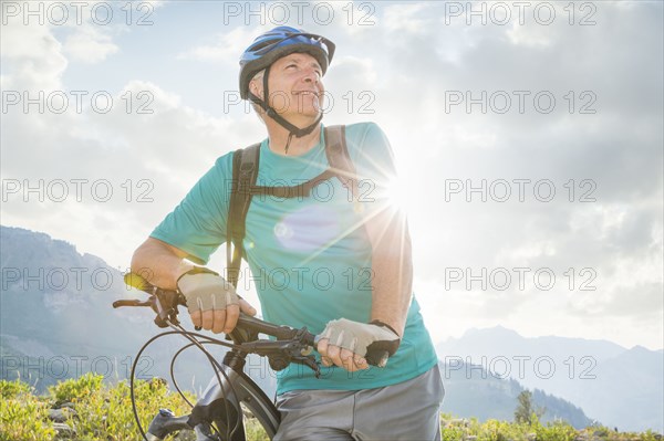 Caucasian man standing with mountain bike