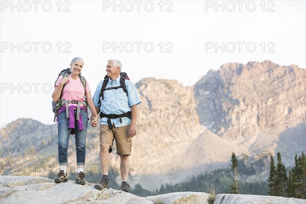 Caucasian couple hiking on mountain