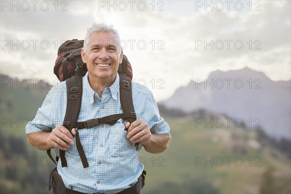 Caucasian man hiking on mountain