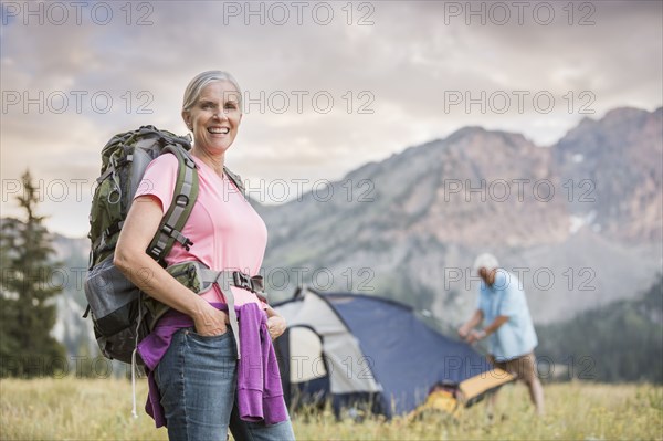 Caucasian couple camping on mountain