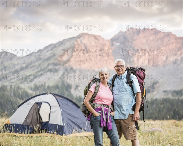 Caucasian couple camping on mountain