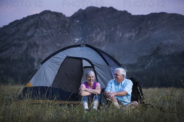 Caucasian couple camping on mountain