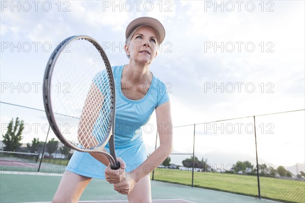 Caucasian woman holding tennis racket