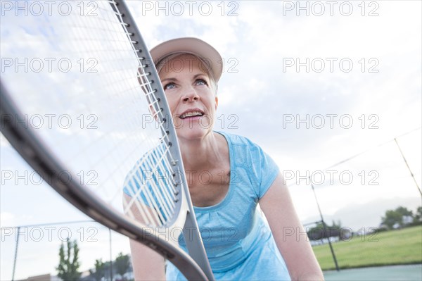 Caucasian woman holding tennis racket