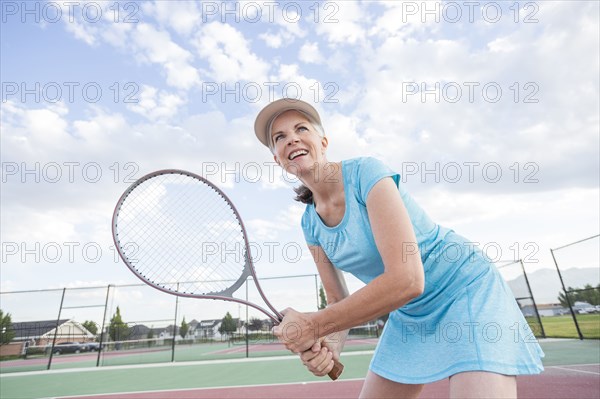 Caucasian woman holding tennis racket