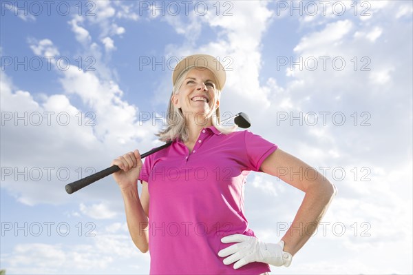 Caucasian woman holding golf club