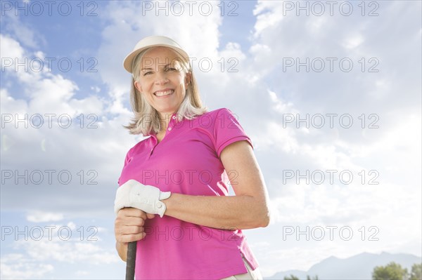 Caucasian woman holding golf club
