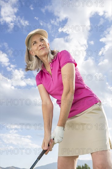 Caucasian woman holding golf club