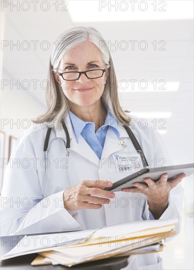 Caucasian doctor holding digital tablet in hospital