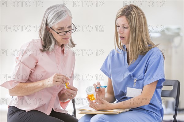 Caucasian nurse explaining prescription to patient