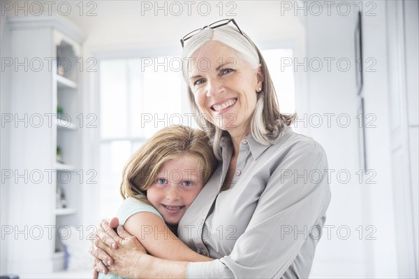 Caucasian grandmother and granddaughter hugging