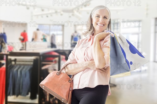 Portrait of Caucasian woman holding shopping bags