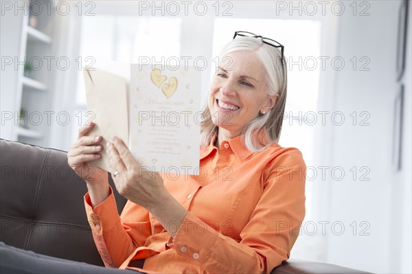 Caucasian women reading greeting card