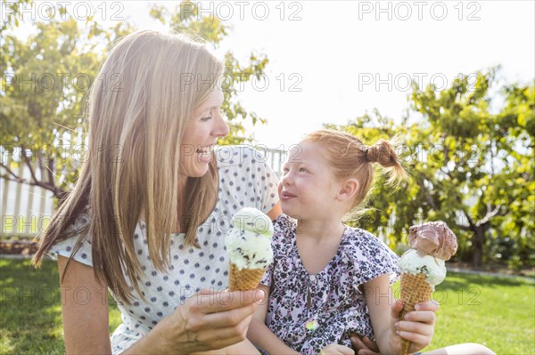 Caucasian mother and daughter eating ice cream cones