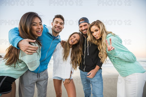 Portrait of smiling friends at beach