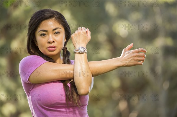 Portrait of Asian woman stretching arms