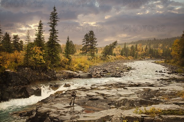 Caucasian man fishing at river