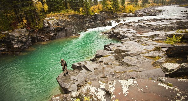 Caucasian man fishing at river