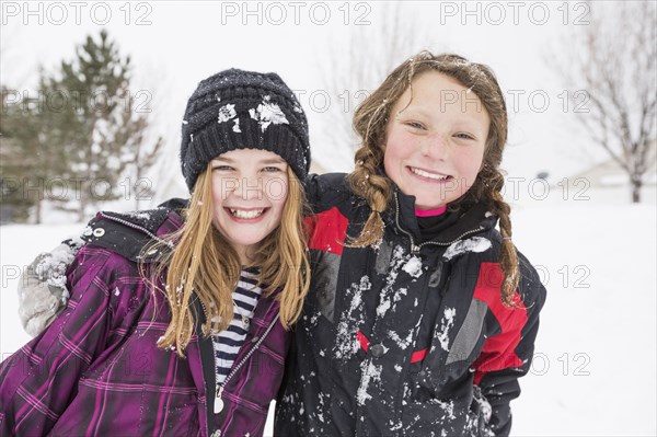 Portrait of girls hugging in winter